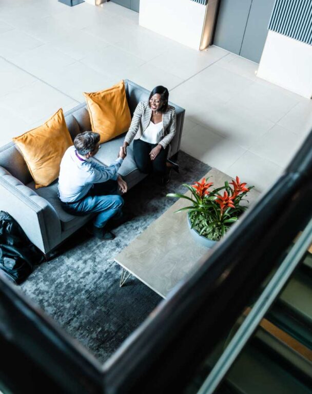 Employees sitting on office couch