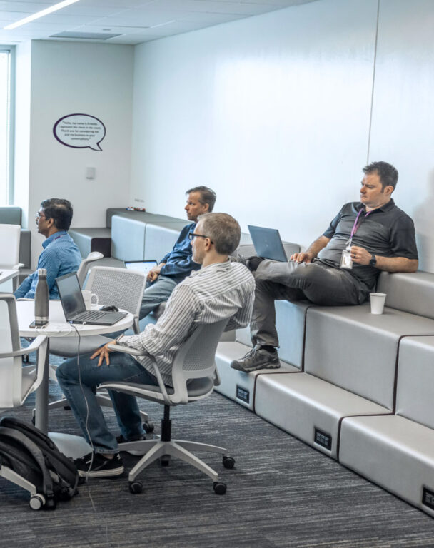 Group of people sitting on steps in an office