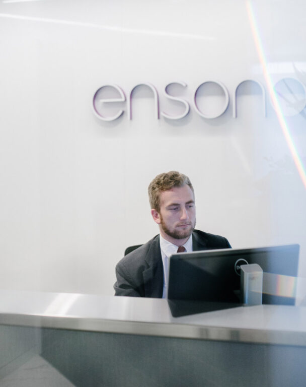 Employee sitting at Ensono Desk