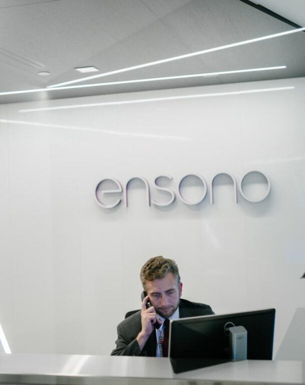 Ensono employee on the phone sitting at a desk