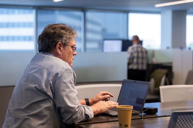 employee sitting at desk with laptop